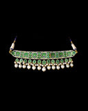 A regal blue enamelled choker set in gold, showcasing bold oversized polki diamonds framed with intricate detailing, finished with cascading South Sea pearl fringes and perfectly matched statement earrings for timeless grandeur. (KMNE3720)