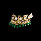 A majestic choker showcasing large polki diamonds set in striking green-enamelled gold, layered with intricate detailing, finished with cascading emerald drops and pearl fringes—opulent, bold, and exquisitely regal. (KMNE3724)