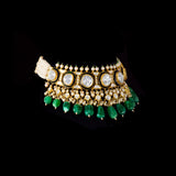 A majestic choker showcasing large polki diamonds set in striking green-enamelled gold, layered with intricate detailing, finished with cascading emerald drops and pearl fringes—opulent, bold, and exquisitely regal. (KMNE3724)