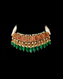 A majestic choker showcasing large polki diamonds set in striking green-enamelled gold, layered with intricate detailing, finished with cascading emerald drops and pearl fringes—opulent, bold, and exquisitely regal. (KMNE3724)