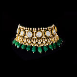 A majestic choker showcasing large polki diamonds set in striking green-enamelled gold, layered with intricate detailing, finished with cascading emerald drops and pearl fringes—opulent, bold, and exquisitely regal. (KMNE3724)
