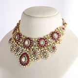 An exquisite fusion-style necklace set featuring sparkling Polki diamonds, brilliant round diamonds, and rich ruby accents, crafted in a bold heavy design to create a luxurious statement with timeless elegance and royal charm. (KMNE3727)