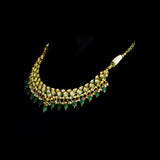 A stunning necklace set with gold and diamond polki, featuring green enamelled detailing, accented with emerald maniya drops and delicate pearls, creating a perfect blend of heritage elegance and vibrant sophistication. (KMNE3732)