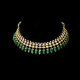 An elegant gold necklace set featuring polki diamonds with blue enamel detailing, accented by emerald maniya and delicate pearl hangings, offering a graceful blend of tradition and refined contemporary luxury. (KMNE3739)