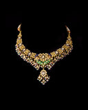 Grand statement necklace and earring pair featuring intricate peacock meenakari in vibrant hues, adorned with uncut diamond polki, highlighted by cascading multicolor beads with pearls, reflecting regal artistry and timeless bridal elegance. (KMNE3743)