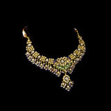 Grand statement necklace and earring pair featuring intricate peacock meenakari in vibrant hues, adorned with uncut diamond polki, highlighted by cascading multicolor beads with pearls, reflecting regal artistry and timeless bridal elegance. (KMNE3743)