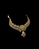 Grand statement necklace and earring pair featuring intricate peacock meenakari in vibrant hues, adorned with uncut diamond polki, highlighted by cascading multicolor beads with pearls, reflecting regal artistry and timeless bridal elegance. (KMNE3743)