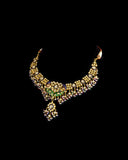 Grand statement necklace and earring pair featuring intricate peacock meenakari in vibrant hues, adorned with uncut diamond polki, highlighted by cascading multicolor beads with pearls, reflecting regal artistry and timeless bridal elegance. (KMNE3743)