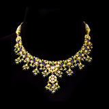 Exquisite gold necklace and earring set featuring uncut diamond polki, peacock meenakari in blue and green, and delicate pearls, blending royal heritage craftsmanship with timeless elegance for statement occasions. (KMNE3746)