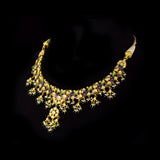 Exquisite gold necklace and earring set featuring uncut diamond polki, peacock meenakari in blue and green, and delicate pearls, blending royal heritage craftsmanship with timeless elegance for statement occasions. (KMNE3746)