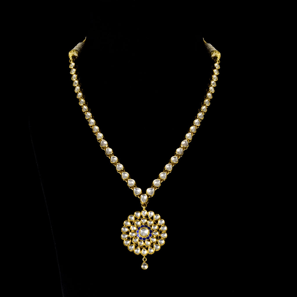 Single-Line Diamond Polki Necklace An elegant single-line diamond polki necklace featuring a beautifully crafted statement pendant, blending timeless artistry with graceful sophistication for every special occasion.(KMNE3755)