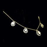 Delicate pear-shaped diamond Polki gracefully framed by shimmering round diamonds, creating a timeless station necklace with effortless elegance and brilliance.(KMNE3775)