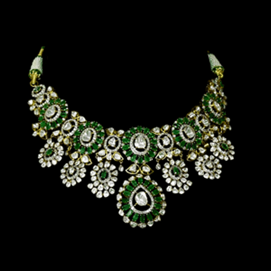 Inspired by royal artistry, this fusion necklace set combines dazzling diamond Polki, brilliant round diamonds, vibrant emeralds, and intricate floral craftsmanship for an effortlessly luxurious statement.(KMNE3782)