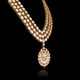 A masterpiece of traditional craftsmanship, this three-line Polki necklace with pendant and earrings radiates enduring elegance and royal charm.(KMNE3785)