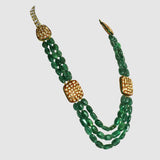 Three strands of vibrant emerald maniya paired with red meenakari diamond Polki motifs create a timeless necklace blending royal heritage with contemporary elegance beautifully.(KMNE3786)