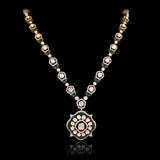 A striking fusion of heritage and modern glamour, this Polki diamond necklace set shines with brilliant diamonds and elegant green stones.(KMNE3791)