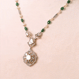 Grace your celebrations with this exquisite Diamond Polki necklace and earrings, accented with brilliant diamonds, emerald maniya, and delicate pearls.(KMNE3792)