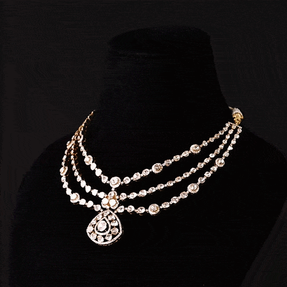 Three radiant strands of handcrafted Diamond Polki, highlighted by shimmering round diamonds and a statement pendant of timeless beauty.(KMNE3793)