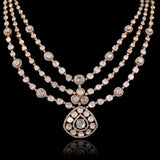 Three radiant strands of handcrafted Diamond Polki, highlighted by shimmering round diamonds and a statement pendant of timeless beauty.(KMNE3793)