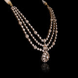 Three radiant strands of handcrafted Diamond Polki, highlighted by shimmering round diamonds and a statement pendant of timeless beauty.(KMNE3793)