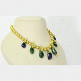 Radiant emerald and sapphire drops, accented with diamond polki, delicately strung with luminous South Sea pearls for timeless elegance and regal sophistication.(KMNE3796)