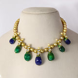 Radiant emerald and sapphire drops, accented with diamond polki, delicately strung with luminous South Sea pearls for timeless elegance and regal sophistication.(KMNE3796)
