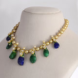 Radiant emerald and sapphire drops, accented with diamond polki, delicately strung with luminous South Sea pearls for timeless elegance and regal sophistication.(KMNE3796)