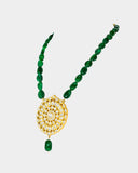 A traditional pendant adorned with hand-set polki diamonds, featuring intricate detailing and timeless elegance. Finished with rich emerald maniya stringing, it celebrates heritage craftsmanship with a touch of regal charm. (KMPE1325)