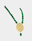 A traditional pendant adorned with hand-set polki diamonds, featuring intricate detailing and timeless elegance. Finished with rich emerald maniya stringing, it celebrates heritage craftsmanship with a touch of regal charm. (KMPE1325)