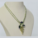 A pendant and earring set featuring diamond polki and round brilliant diamonds, accented with green and blue French enamel. Designed in a refined fusion style, it blends traditional artistry with a contemporary touch, ideal for festive occasions(KMPE1348)