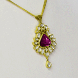 An elegant pendant featuring diamond polki with a striking central tourmaline, blending classic craftsmanship with vibrant colour for a timeless statement. (KMPE1353)