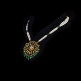 Graceful peacock pendant set adorned with diamond polki, delicately strung with pearls and emerald maniya, celebrating timeless heritage and refined elegance.(KMPE1364)