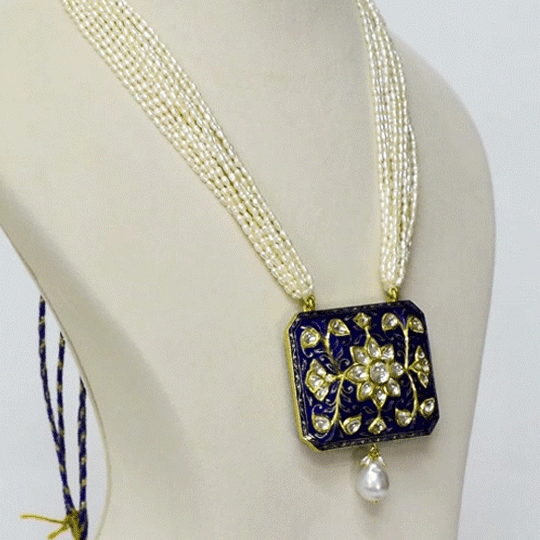 A stunning blue meena pendant adorned with sparkling diamond polki, beautifully strung with lustrous pearls. This traditional design blends vibrant enamel artistry with timeless elegance, perfect for festive occasions.(KMPE1365)