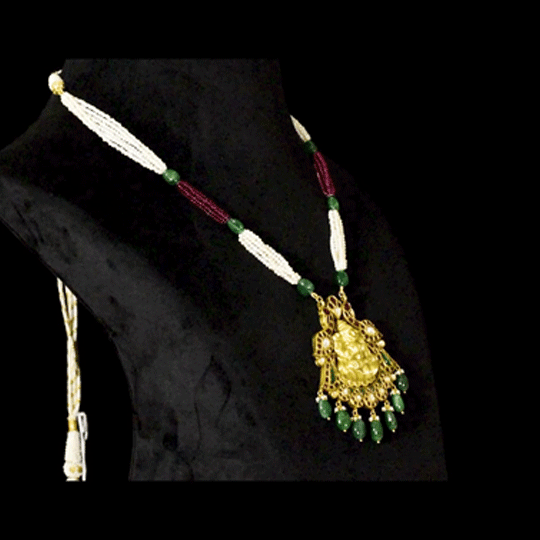 Divine Temple Pendant Exquisite temple-style pendant featuring Goddess Lakshmi, sparkling diamond polki, vibrant coloured gemstones, and emerald drops, celebrating timeless heritage and divine elegance.(KMPE1373)