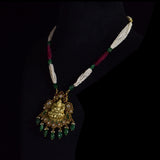 Divine Temple Pendant Exquisite temple-style pendant featuring Goddess Lakshmi, sparkling diamond polki, vibrant coloured gemstones, and emerald drops, celebrating timeless heritage and divine elegance.(KMPE1373)