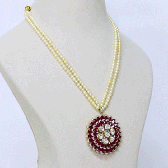 Fusion Ruby Pearl Pendant Contemporary pendant showcasing vibrant rubies, diamond polki and brilliant diamonds, gracefully suspended from a luminous double-strand pearl necklace for timeless sophistication.(KMPE1389)