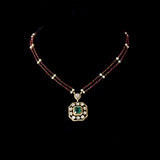 Fusion Emerald Pendant Set Contemporary pendant set featuring a vivid emerald, diamond polki and brilliant diamonds, gracefully strung with ruby and pearl in gold-wire chain for refined elegance.(KMPE1401)