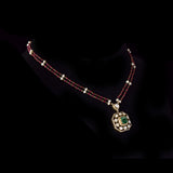 Fusion Emerald Pendant Set Contemporary pendant set featuring a vivid emerald, diamond polki and brilliant diamonds, gracefully strung with ruby and pearl in gold-wire chain for refined elegance.(KMPE1401)