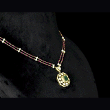 Fusion Emerald Pendant Set Contemporary pendant set featuring a vivid emerald, diamond polki and brilliant diamonds, gracefully strung with ruby and pearl in gold-wire chain for refined elegance.(KMPE1401)