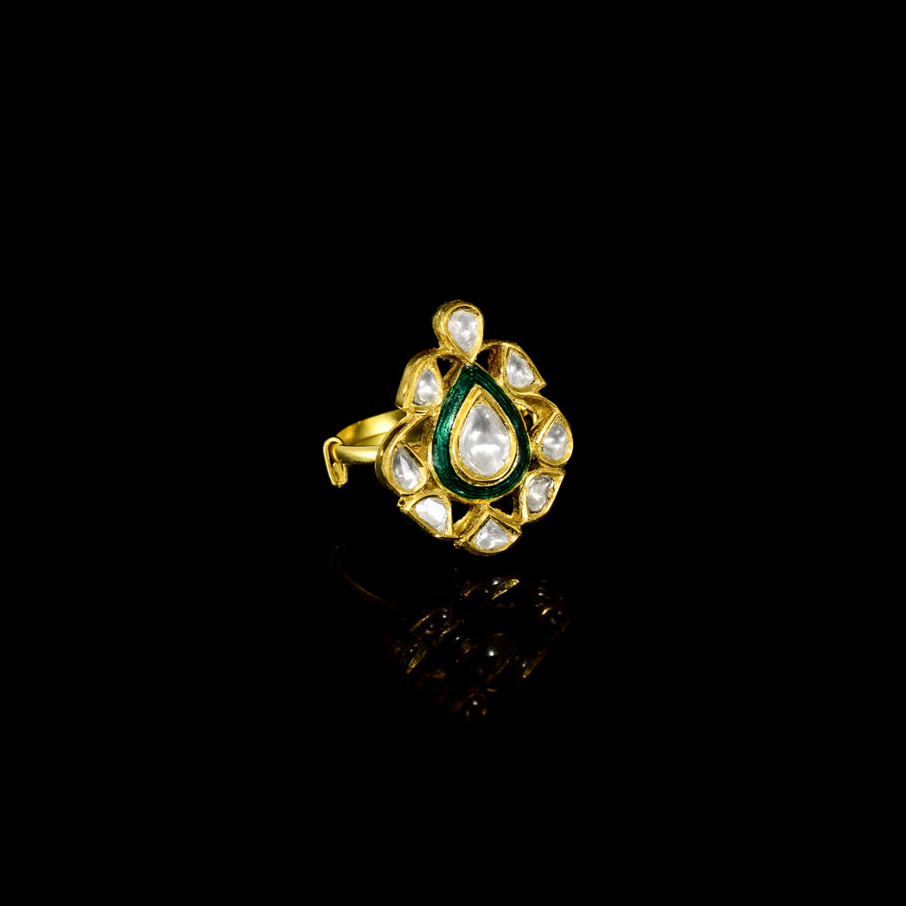 Grace your fingers with this green enameled ring, featuring uncut diamond Polki. Adjustable in size, it blends traditional charm with modern comfort for effortless elegance.(KMR0173)