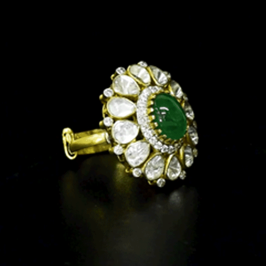 Emerald Halo Ring A vivid emerald takes center stage, encircled by radiant diamond polki and brilliant diamonds, creating a timeless statement of refined luxury.(KMR0180)