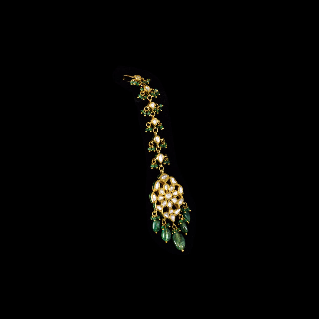 Elevate your elegance with this Ekposta Maangtika, featuring uncut diamond Polki and delicately strung with rich emerald beads.(KMTK0237)