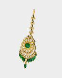 A regal maangtika adorned with diamond polki and a radiant emerald centre, finished with emerald and pearl stringing for timeless elegance and traditional bridal charm. (KMTK0243)