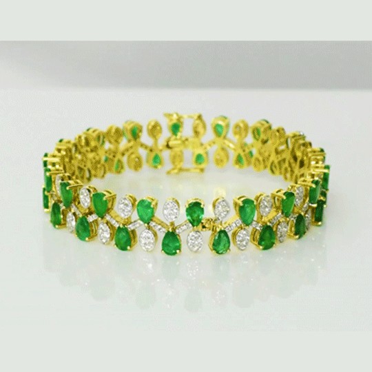 Emerald Diamond Bangle Elegant bangle adorned with vibrant pear-shaped emeralds and brilliant diamonds, beautifully arranged in a graceful floral pattern for timeless sophistication and luxury.(PGDB078)