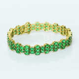 Vivid green emeralds arranged in a graceful flow, highlighted with subtle diamond brilliance for a sophisticated finish. (PGDBR063)