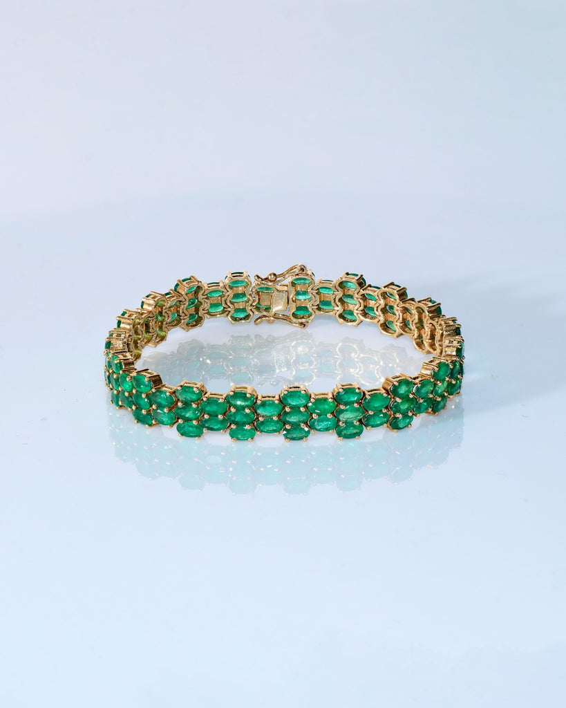 Vivid green emeralds arranged in a graceful flow, highlighted with subtle diamond brilliance for a sophisticated finish. (PGDBR063)