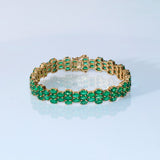 Vivid green emeralds arranged in a graceful flow, highlighted with subtle diamond brilliance for a sophisticated finish. (PGDBR063)