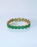 Vivid green emeralds arranged in a graceful flow, highlighted with subtle diamond brilliance for a sophisticated finish. (PGDBR063)