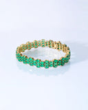 Vivid green emeralds arranged in a graceful flow, highlighted with subtle diamond brilliance for a sophisticated finish. (PGDBR063)