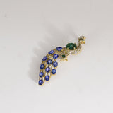 Royal Peacock Brooch Elegant peacock brooch adorned with vivid blue sapphires, rich emerald, and brilliant diamonds, beautifully capturing regal grace and timeless sophistication.(PGDBRCH002)